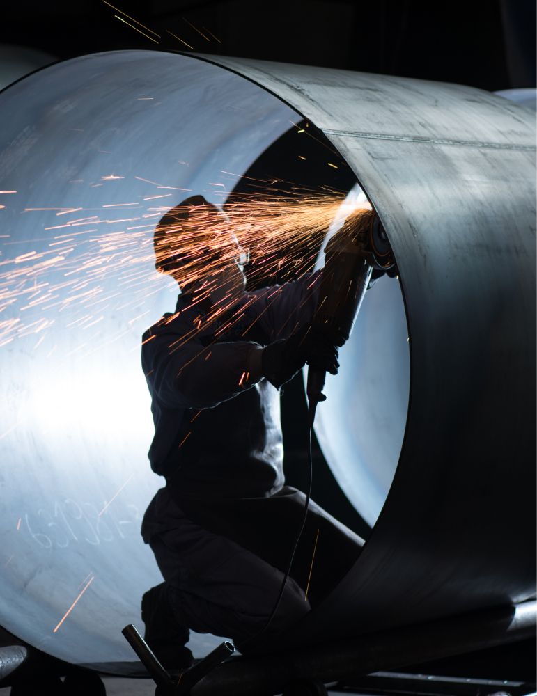 Welder at work in an open cylinder