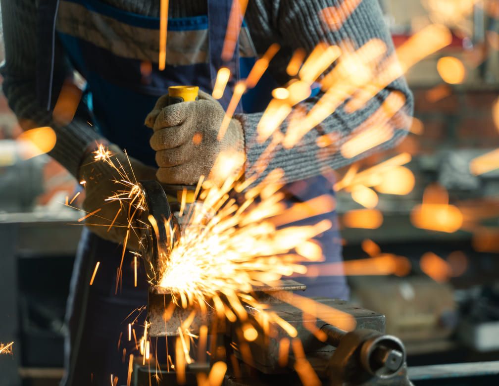 Man in blue overall welding