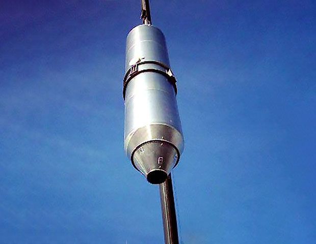 Metal silos from below in front of the sky