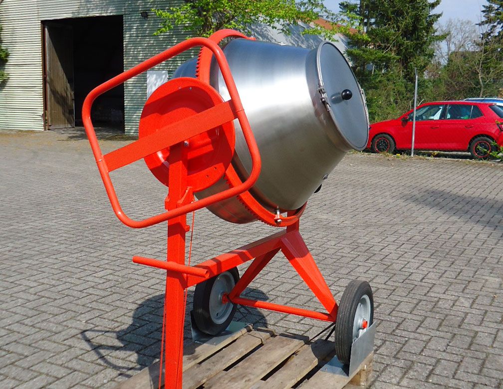 Red concrete mixer in a parking lot